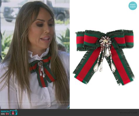 Kelly’s Gucci brooch and belt on The Real Housewives of